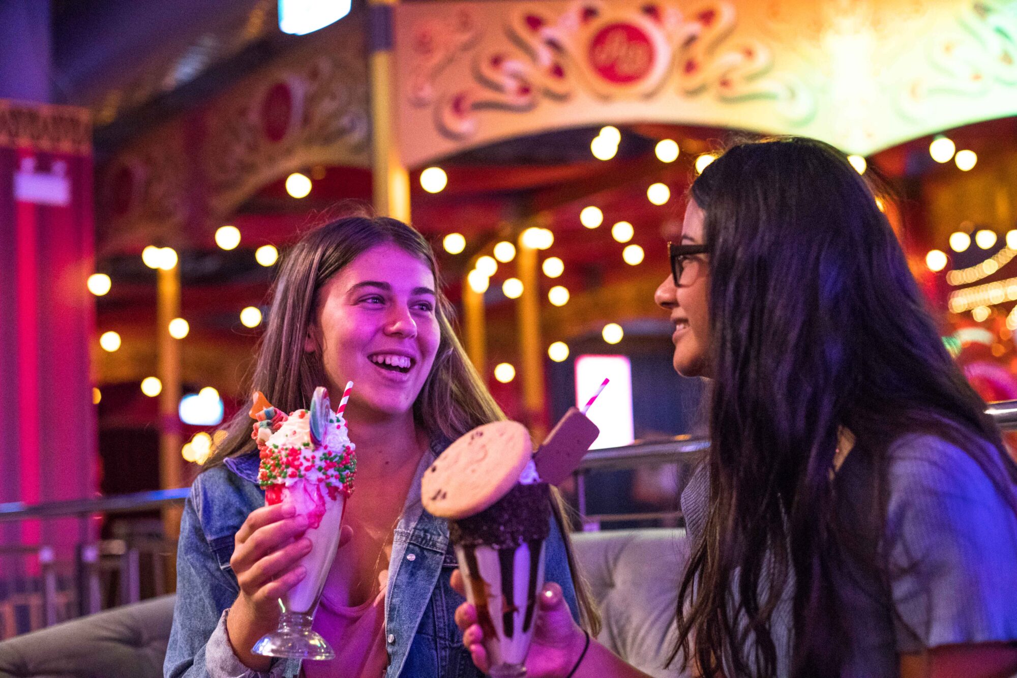 Girls enjoying a milkshake together